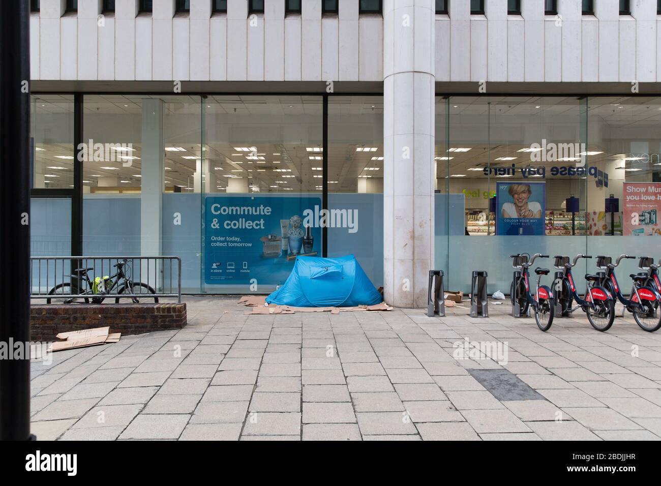 Tent erected by rough sleeper outside Boots Charing Cross London Stock