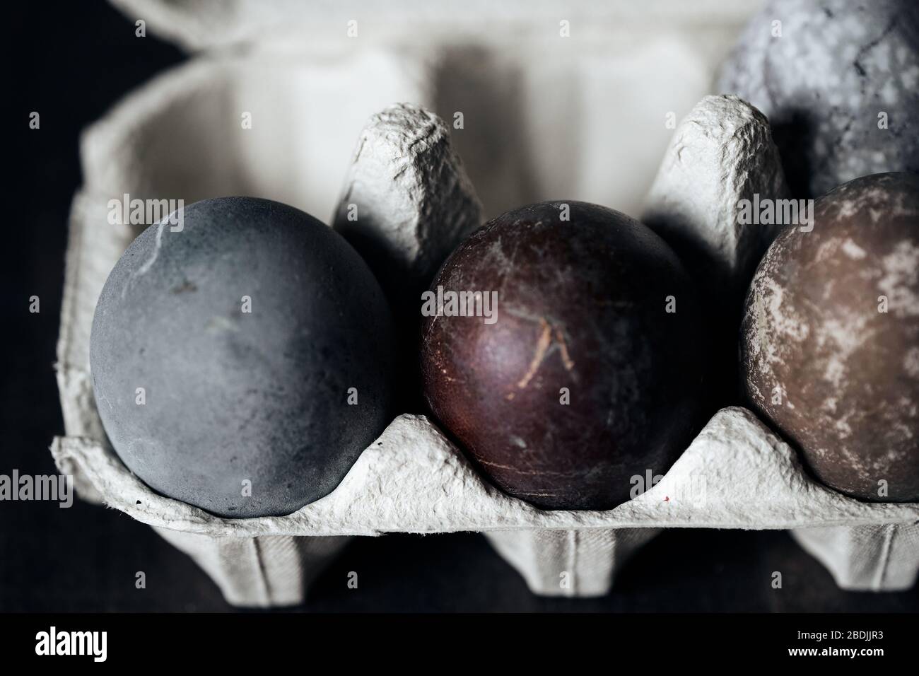 Easter eggs in eggs box, naturally dyed with red grape juice. Selective focus. Stock Photo