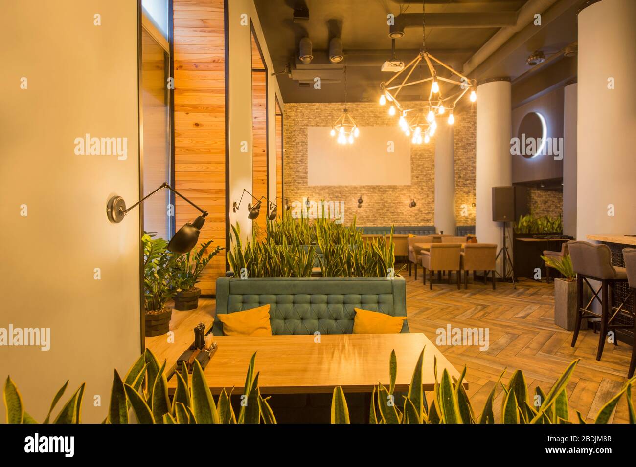 Light modern interior of urban restaurant or cafe with dining places ...