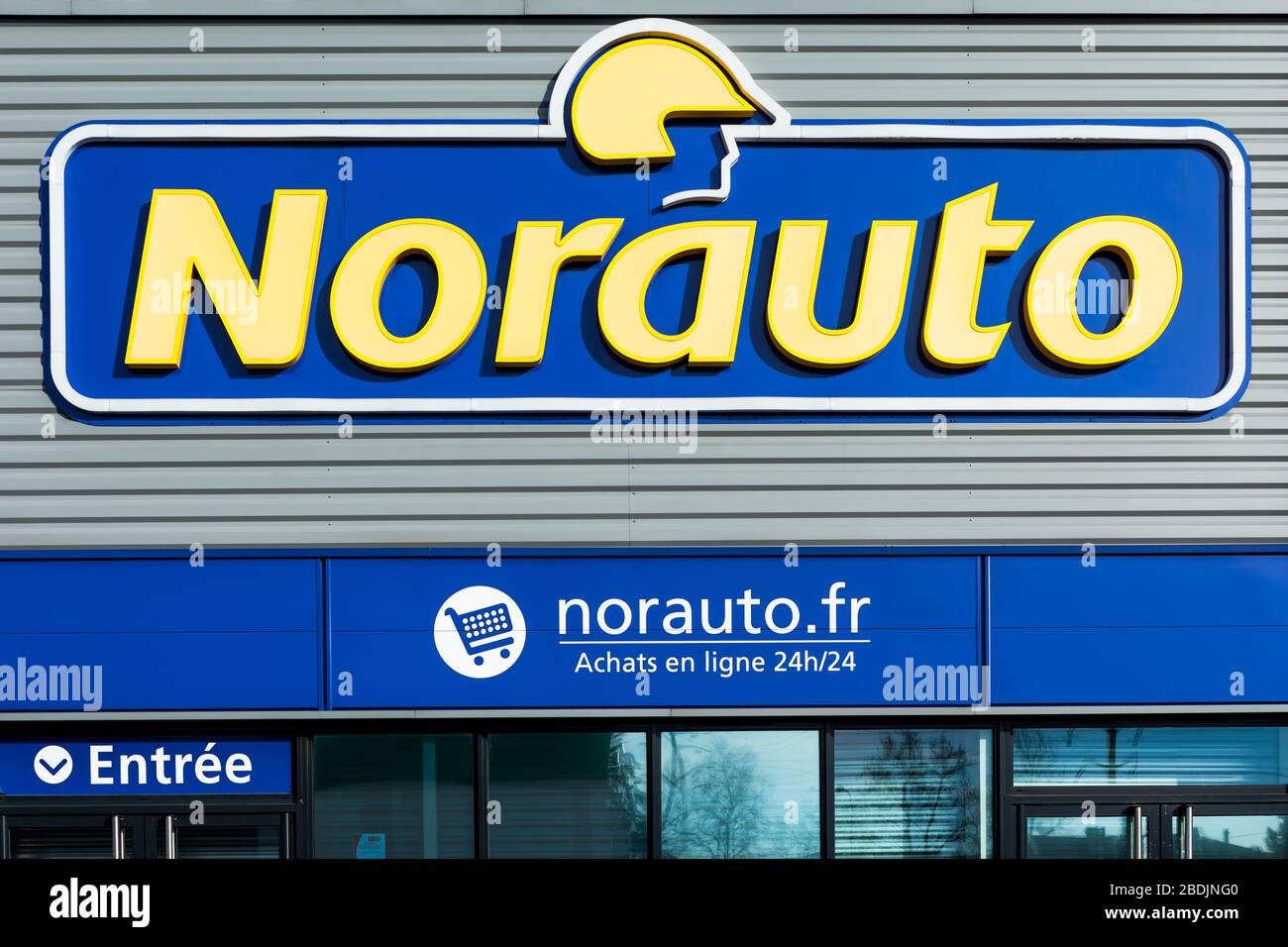 Norauto Groupe brand logo on bright blue sky background. Car parts shop and service station located on its dealer building in Lyon, France - February Stock Photo