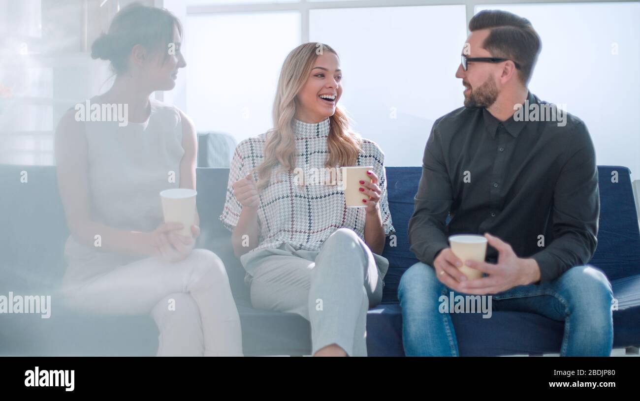 business team sitting in the office lobby at work break Stock Photo - Alamy