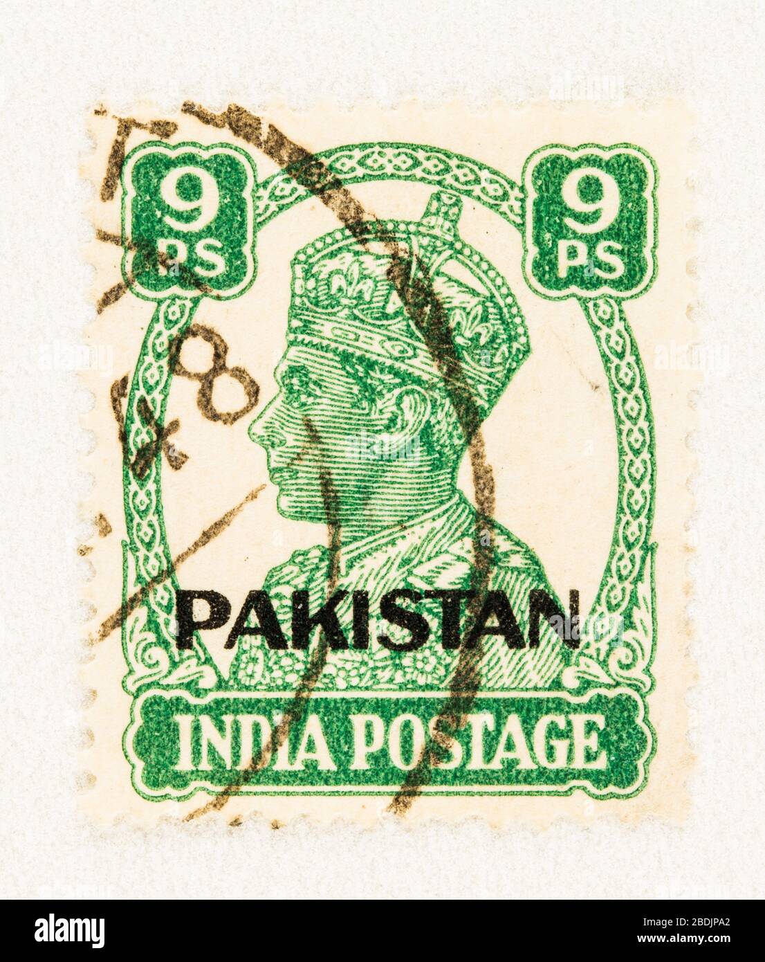SEATTLE WASHINGTON - April 3, 2020: Close up of green 1947 India stamp overprint Pakistan, featuring King George VI.  Scott # 3. Stock Photo