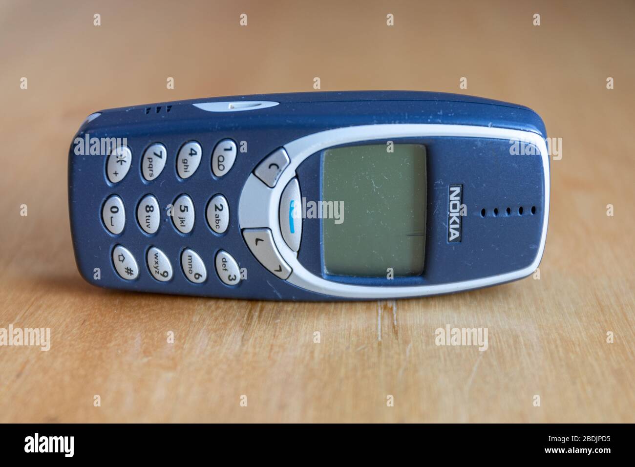 Iconic Nokia 3310, a GSM mobile phone released in 2000, one of the most successful phones with 126 million units sold worldwide Stock Photo