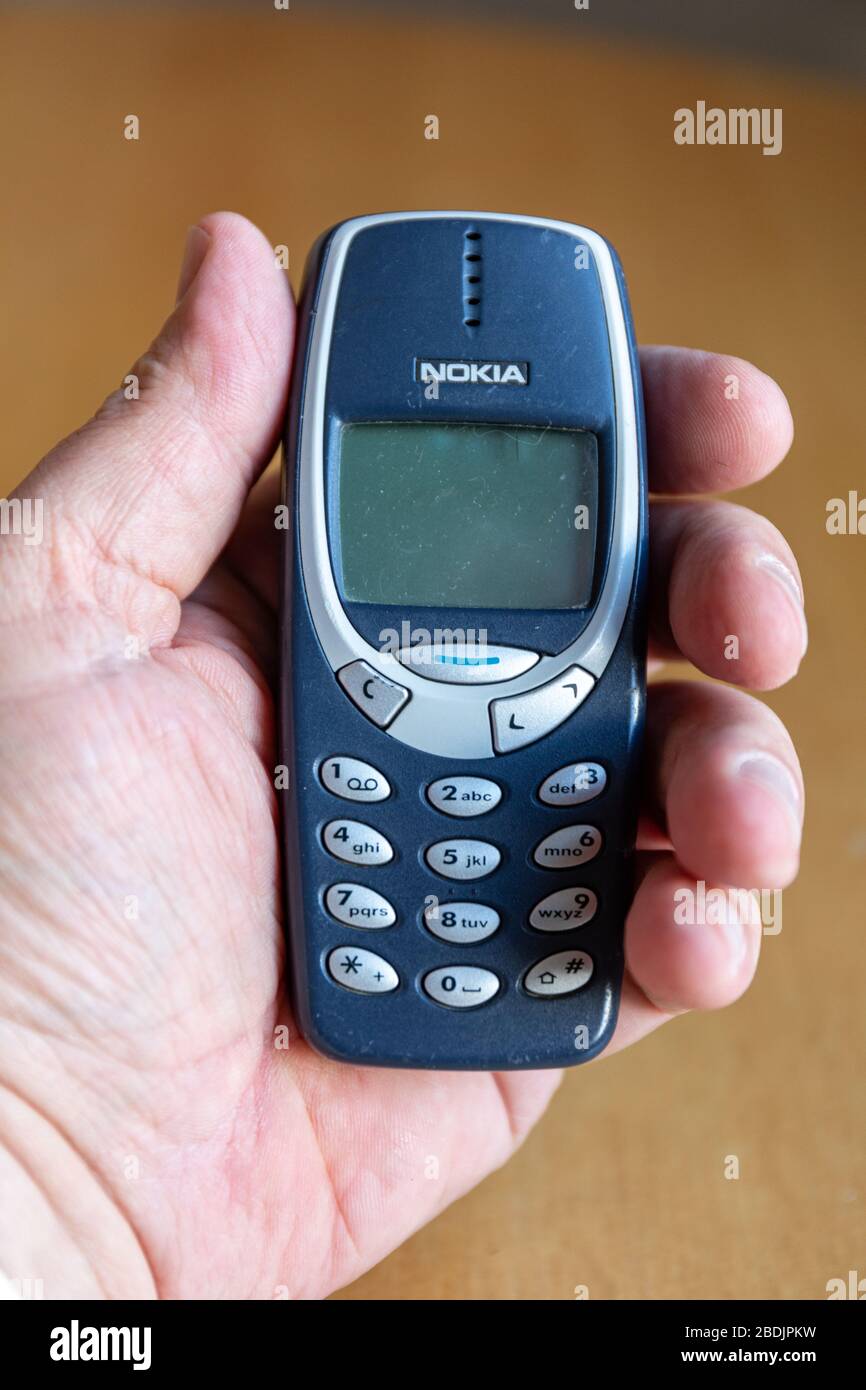 Iconic Nokia 3310, released in 2000, one of the most successful phones with 126 million units sold worldwide Stock Photo