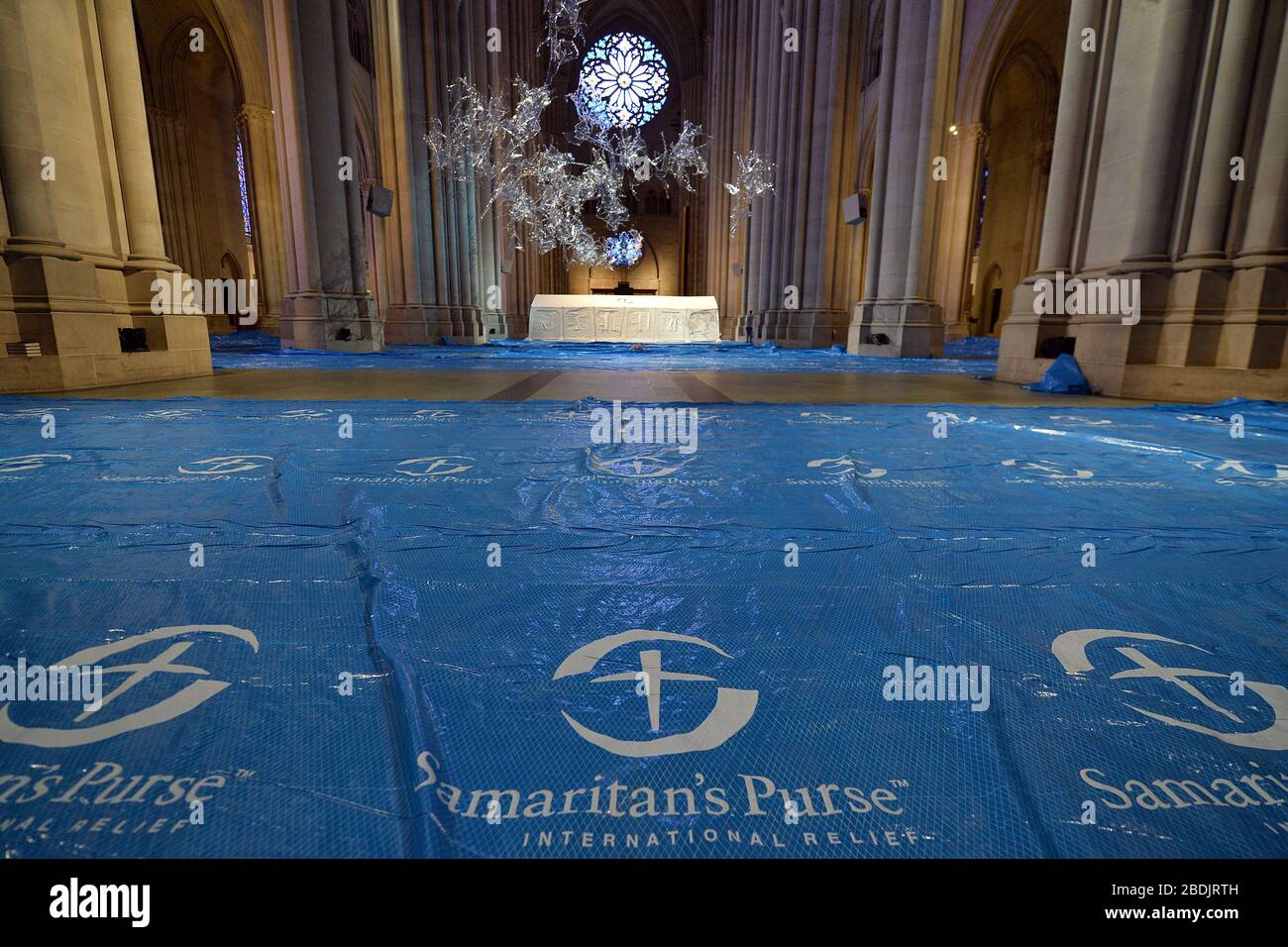 New York City, USA. 08th Apr, 2020. The first of several tents is erected inside the great gothic Cathedral of St. John the Devine as it is transformed into an emergency Coronavirus field hospital by Samaritan's Purse in New York, NY, April 8, 2020. The 600-foot long cathedral is partnering with Mount Sinai Morningside Hospital to have 400 beds to treat COVID-19 patients. (Anthony Behar/Sipa USA) Credit: Sipa USA/Alamy Live News Stock Photo