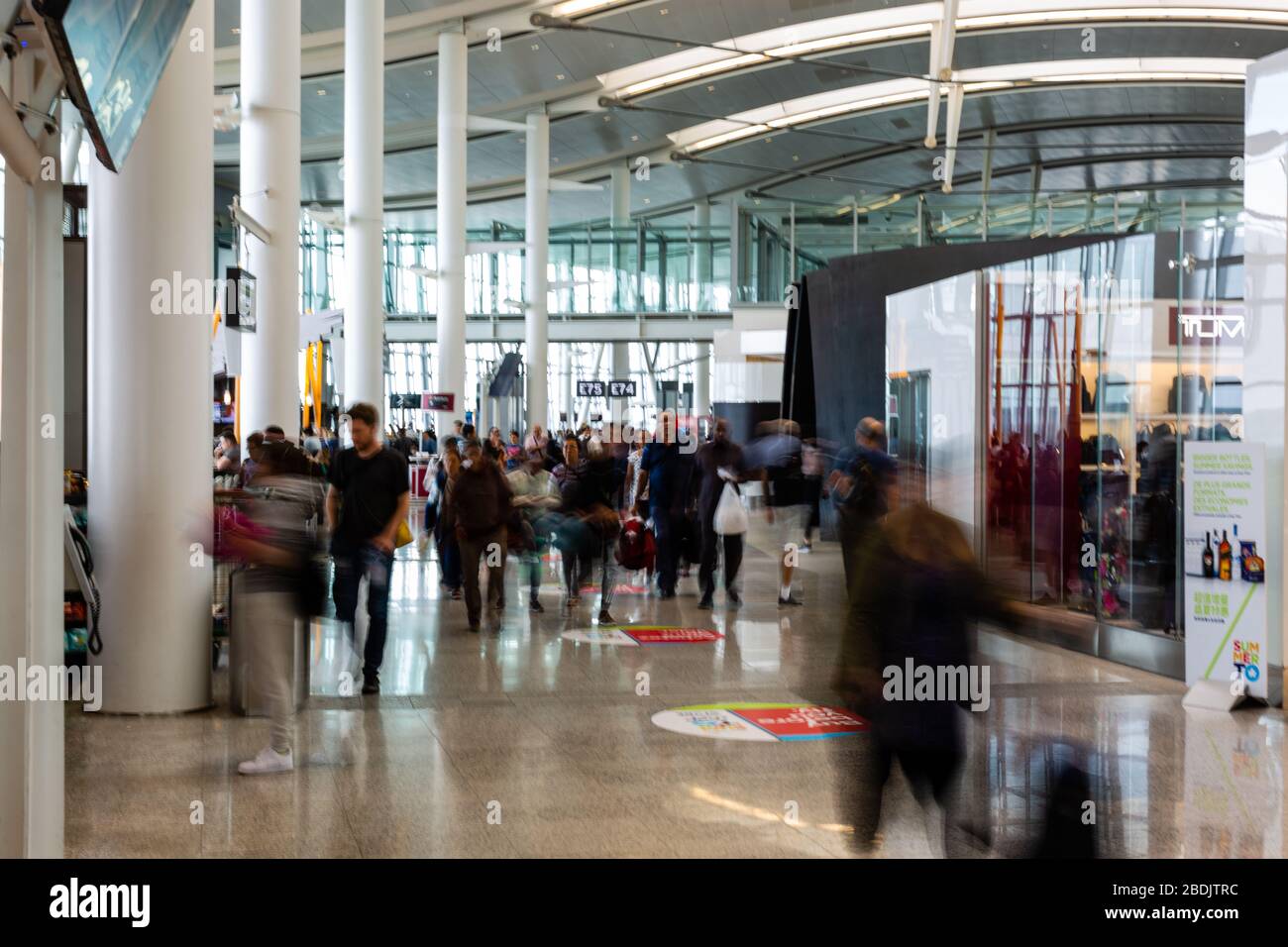Passengers scurry through the departures level to get to the right gate for their flight inside Pearson International Airport in Mississauga, Canada. Stock Photo