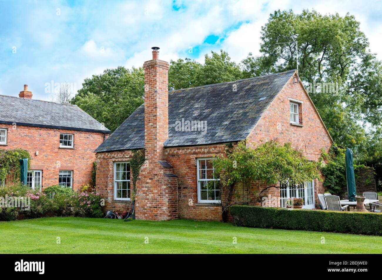 Old garage converted to rental cottage on family estate near Broadway, Worcestershire, England, UK Stock Photo