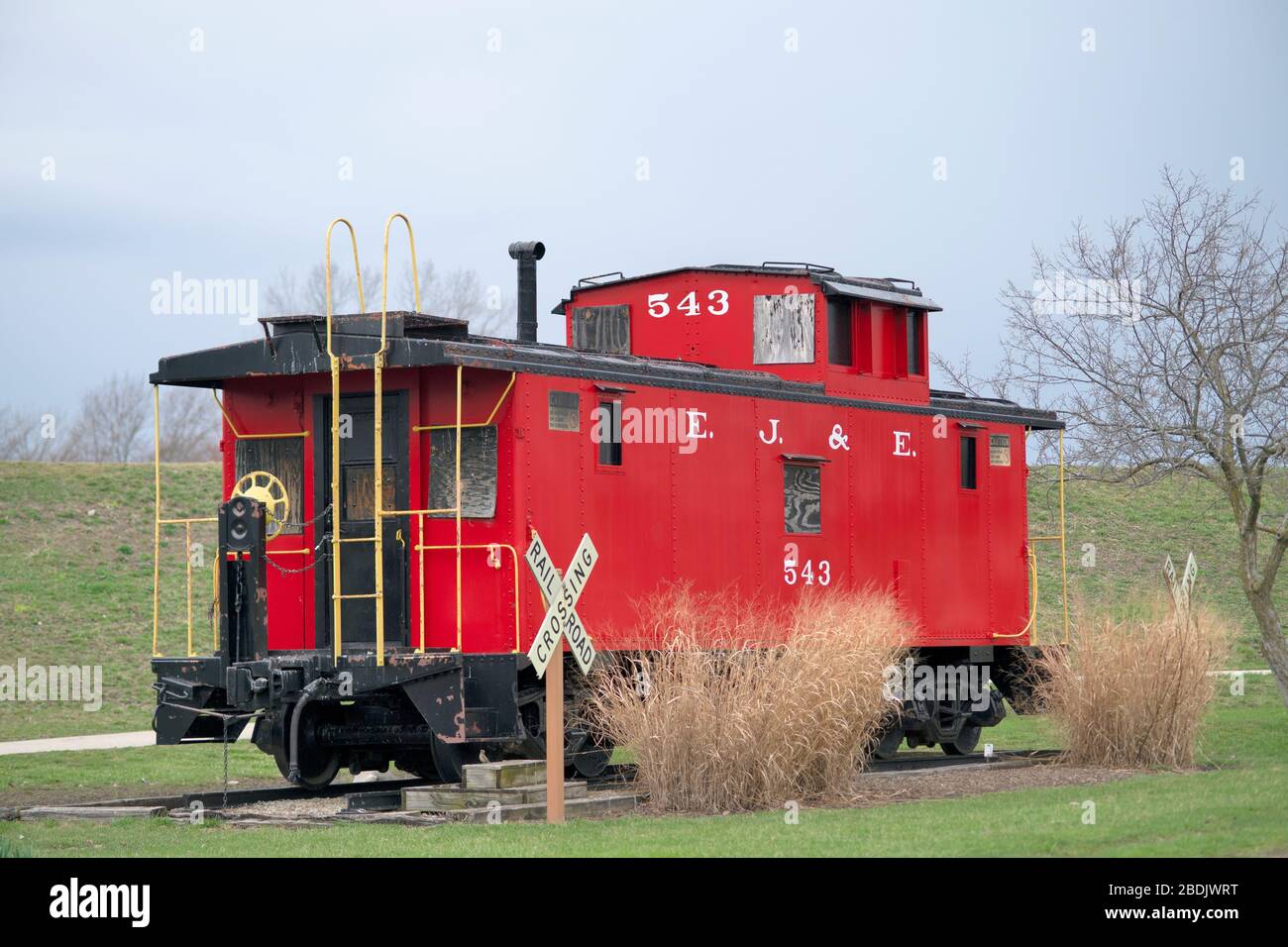 Carol Stream, Illinois, USA. A donated caboose sits in a park in a Chicago suburb representing a symbol of a bygone era. Stock Photo