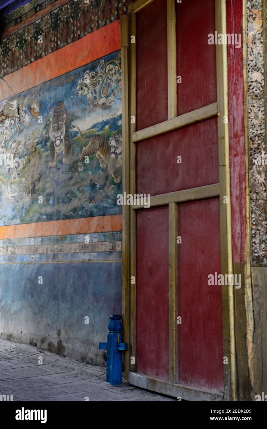 Colorfully painted walls and doorways decorate the exterior of the Pelkor Chode Monastery in Gyantse in the Autonomous Region of Tibet. Stock Photo
