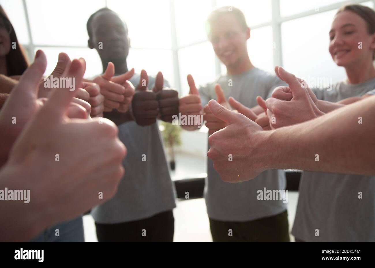 close up. group of young people showing thumbs up Stock Photo - Alamy