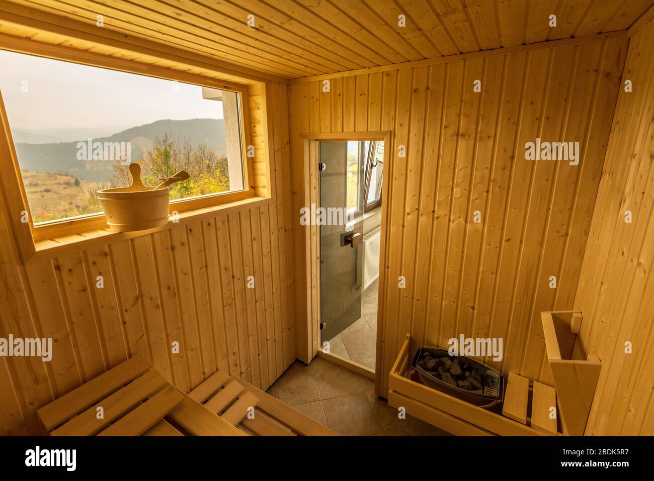 Wooden sauna with seats. Accessories interior of sauna spa. Stock Photo