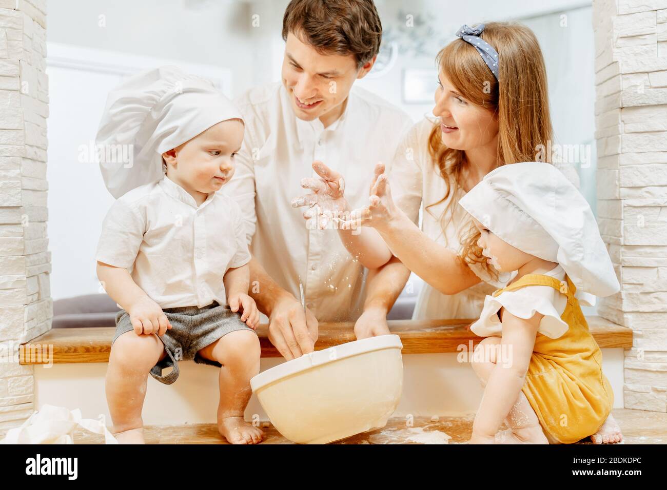 Happy young caucasian family mom dad in white cap Stock Photo - Alamy