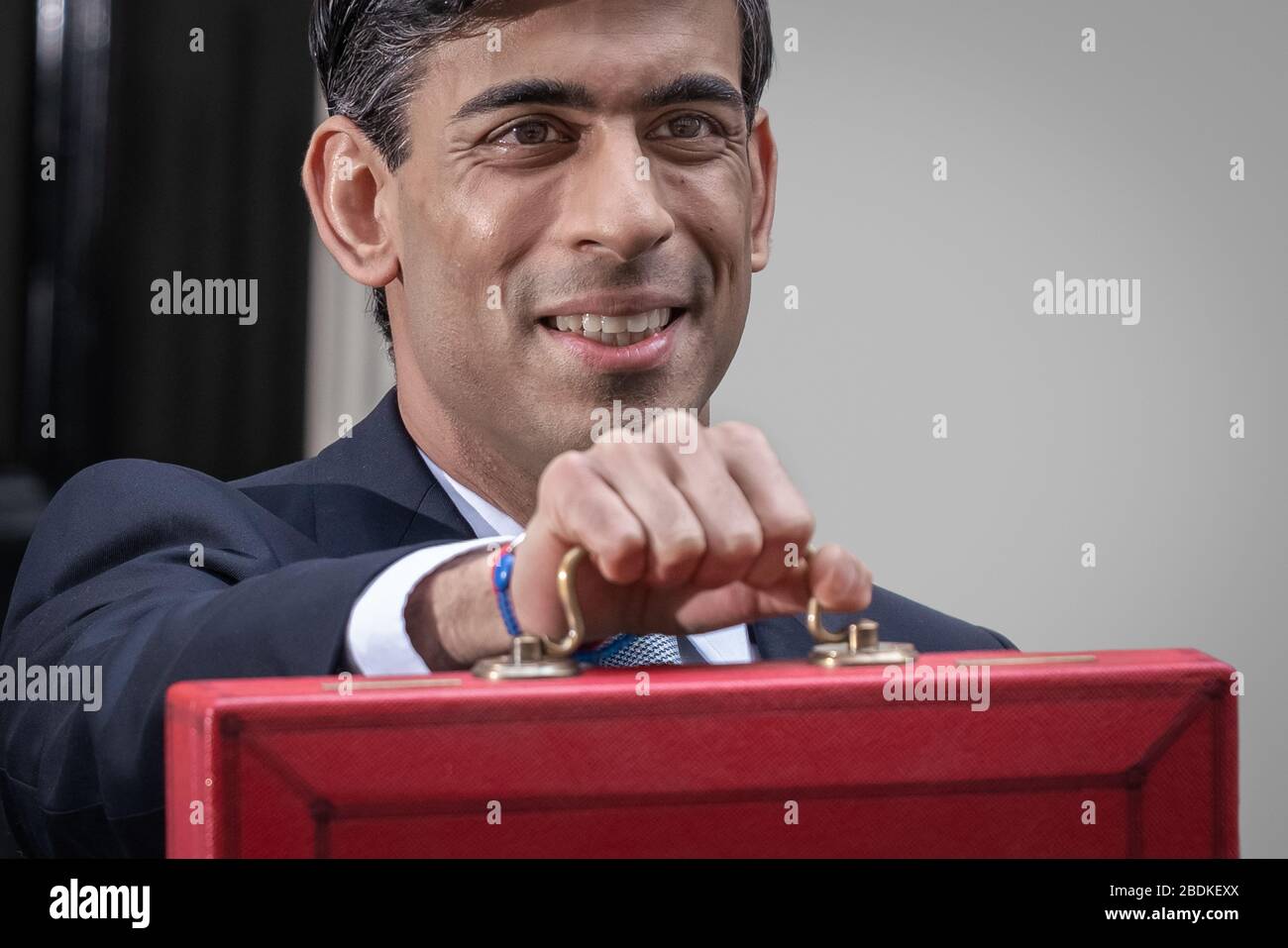 Budget 2020: Chancellor Rishi Sunak poses outside 11 Downing Street with the red Budget box before delivering his first budget statement. London, UK Stock Photo