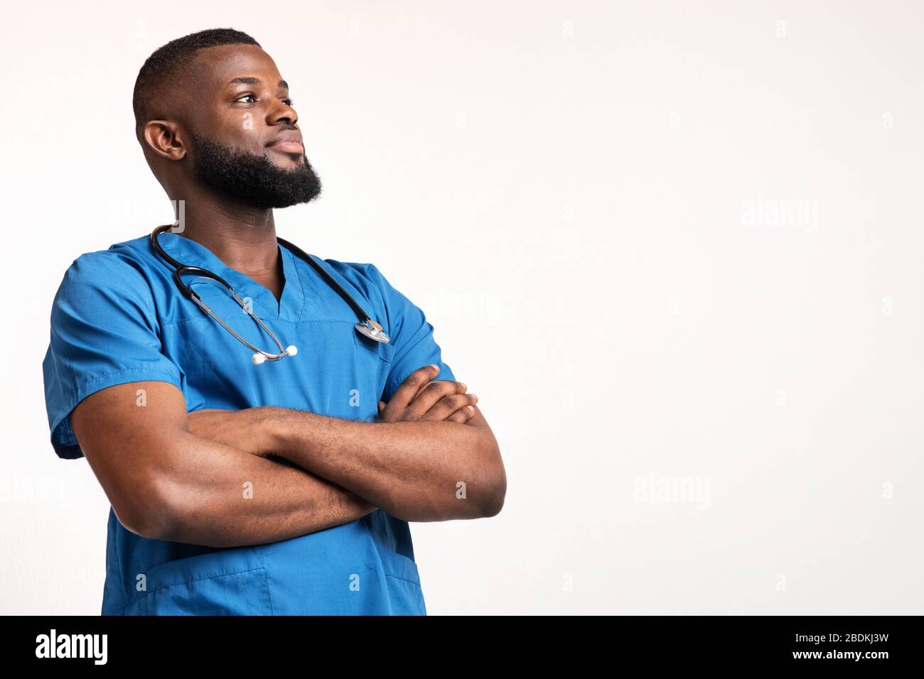 Confident black doc with arms crossed looking at free space Stock Photo
