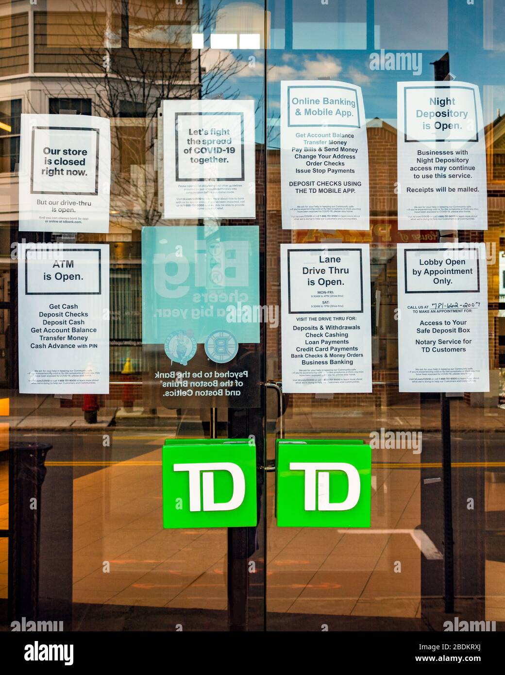 A local bank uses its glass door as a bulletin board for directing