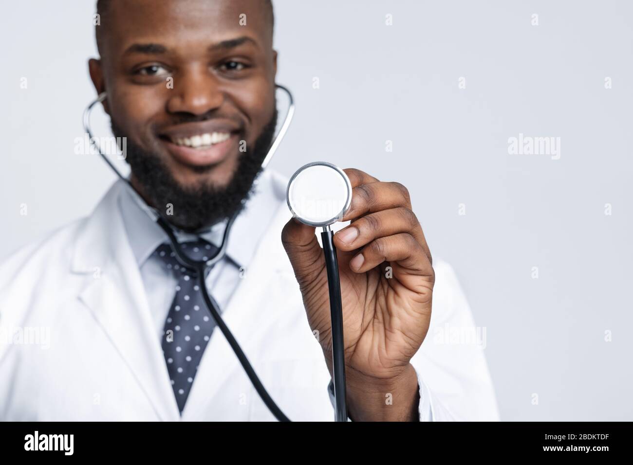 Close up of smiling therapist using stethoscope Stock Photo