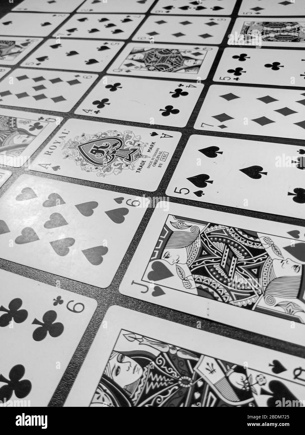Playing cards in wooden table black and white enjoy your game Stock Photo
