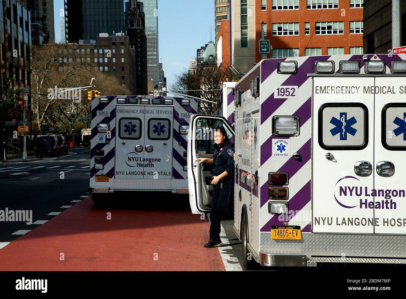 New York, United States. 07th Apr, 2020. An EMT exits an ambulance parked in front of NYU Langone Hospital. With the mounting cases of COVID-19, the call centers around the city have seen a 50 percent rise in 911 calls overwhelming the Emergency Services Technicians personnel. Consequently, FEMA has sent 250 ambulances and 500 EMT personnel to New York. Additionally, while there are no exact numbers of personal protective equipment (PPE) FEMA has sent to hospitals, shortages continue. Credit: SOPA Images Limited/Alamy Live News Stock Photo