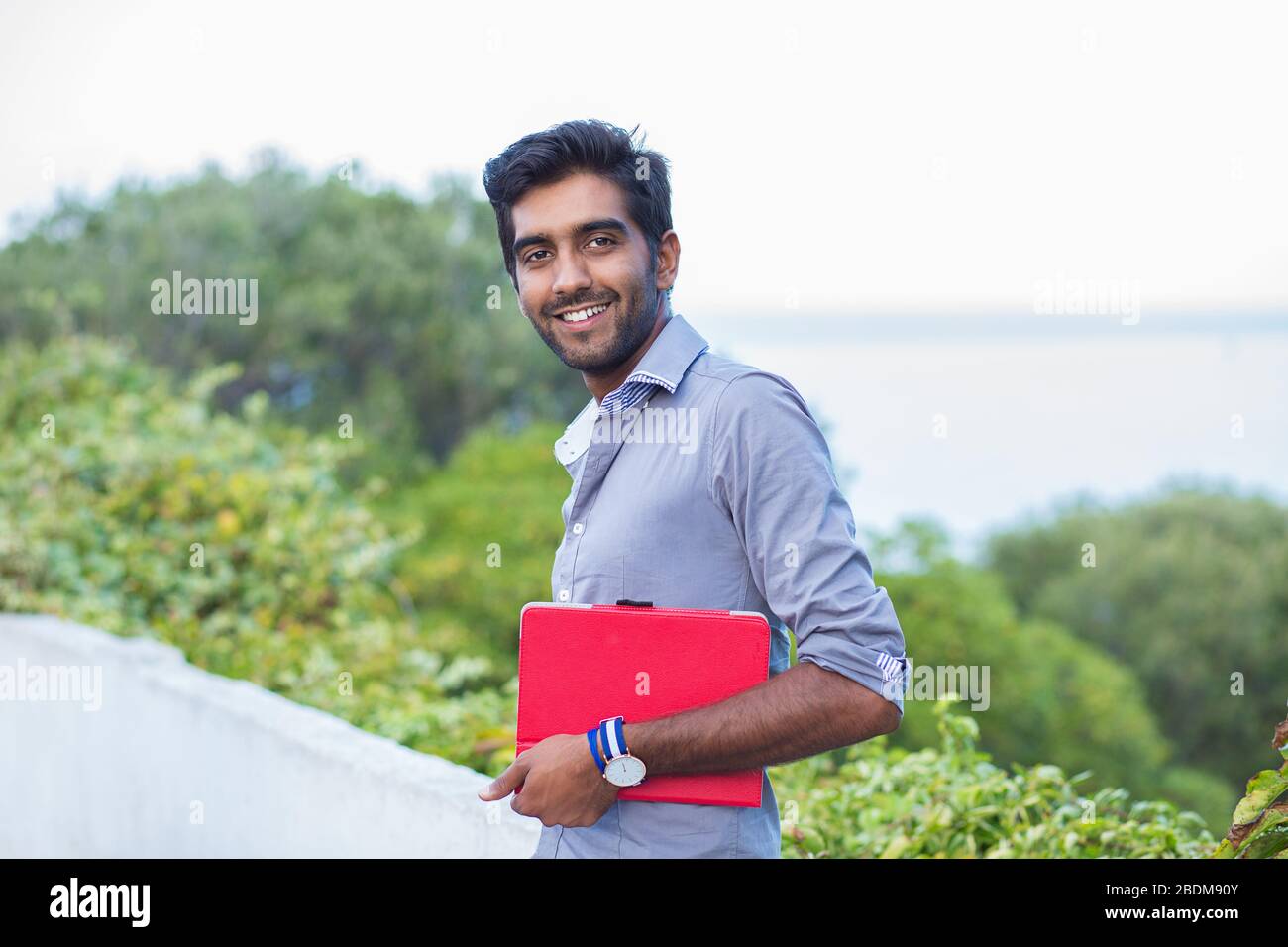 Indian man student. Closeup photo of attractive, handsome entrepreneur smiling. Positive human emotions face expression. The person in shirt isolated Stock Photo