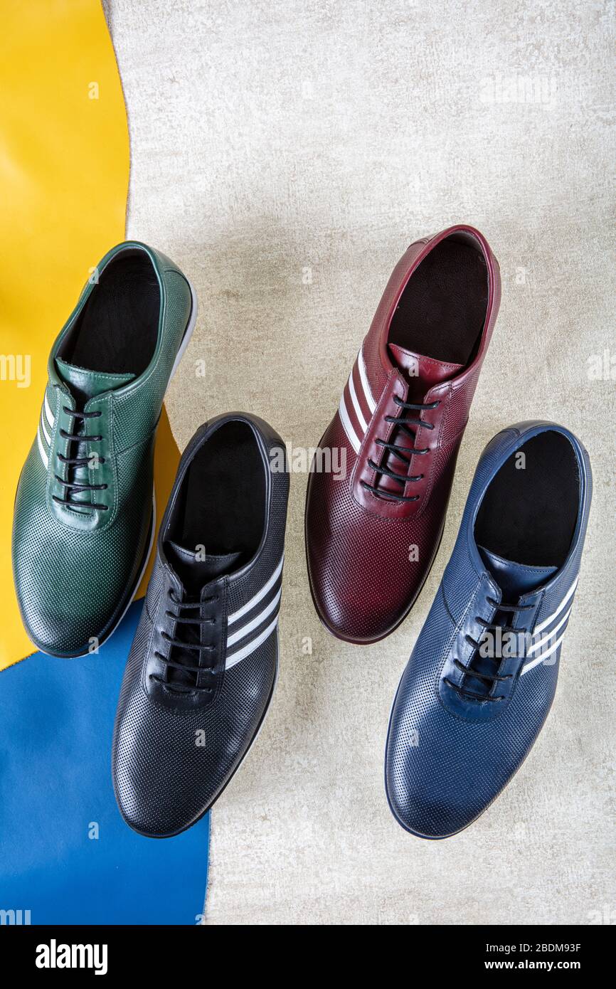 handmade leather shoes on different colored leather pieces. men fashion ...