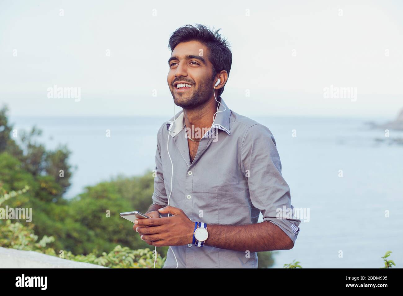 Indian guy listening music headset hi-res stock photography and images ...