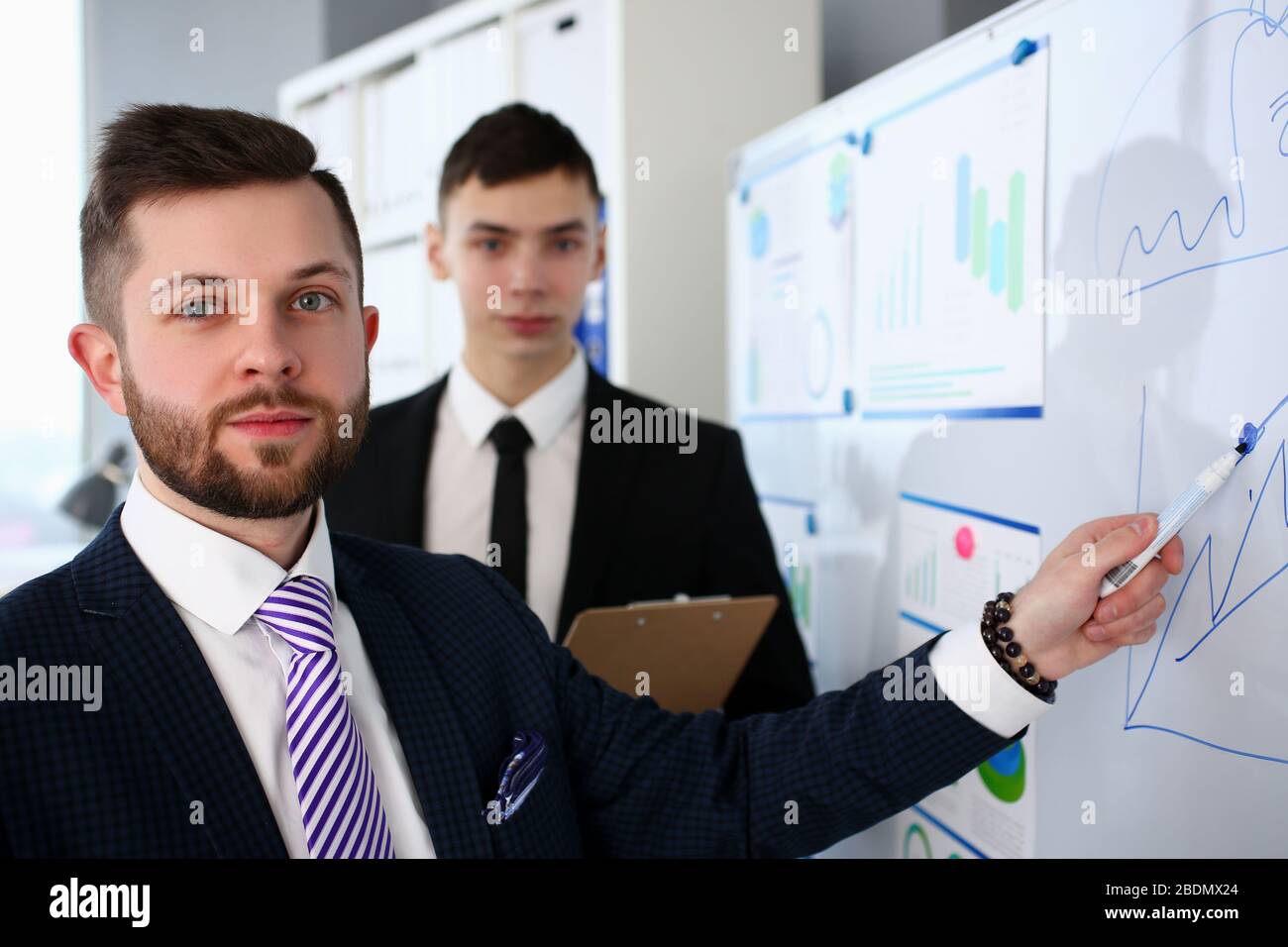 Smiling handsome bearded caucasian man in office telling something important Stock Photo
