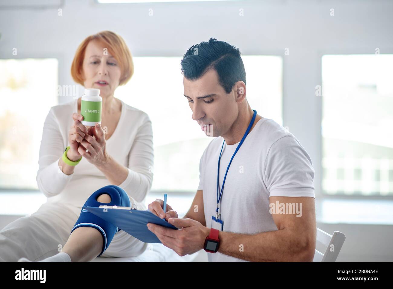 Nice professional male doctor writing a prescription Stock Photo