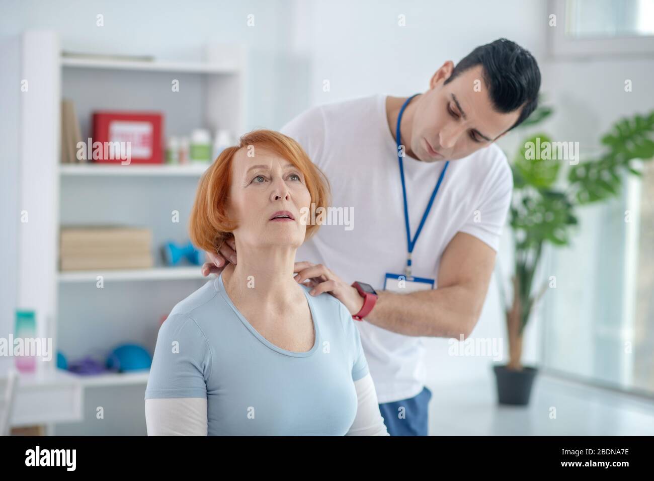 Nice aged woman having a neck massage Stock Photo