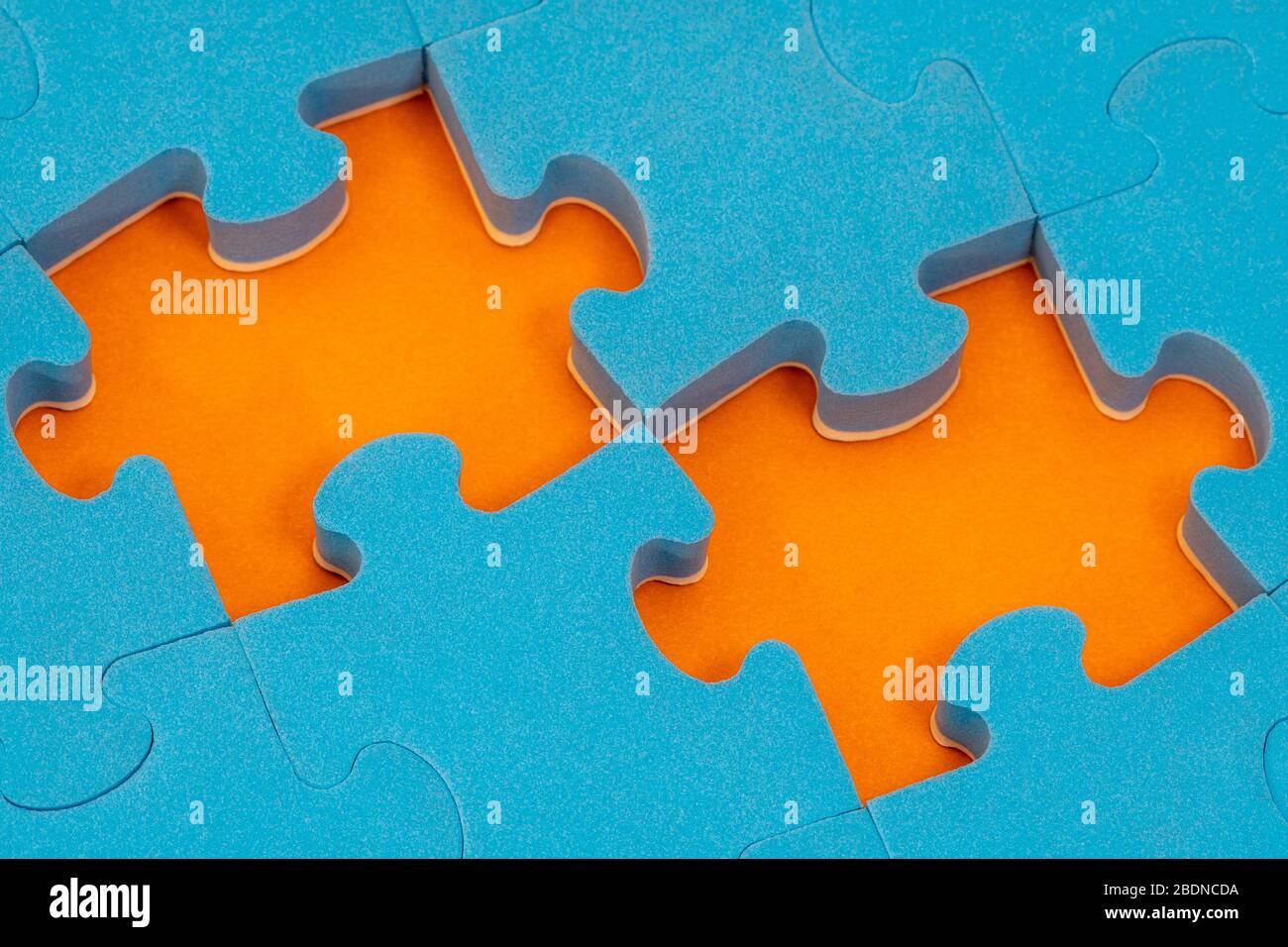 Blue jigsaw puzzle with two missing pieces. Make a right choice or  decision.Undecided about what to do. Help with advice Stock Photo - Alamy