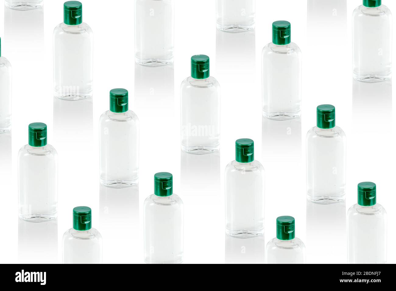 Pattern made with virus prevention medical hand sanitizer gel for hand hygiene, bottles with closed green cups. Covid-19 protection. Global pandemic concept. Stock Photo