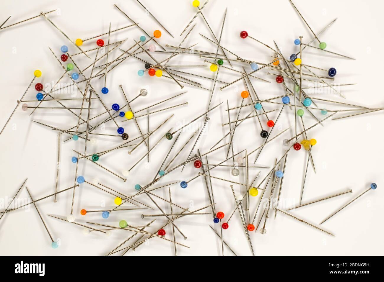 Colorful pins on white background Stock Photo - Alamy
