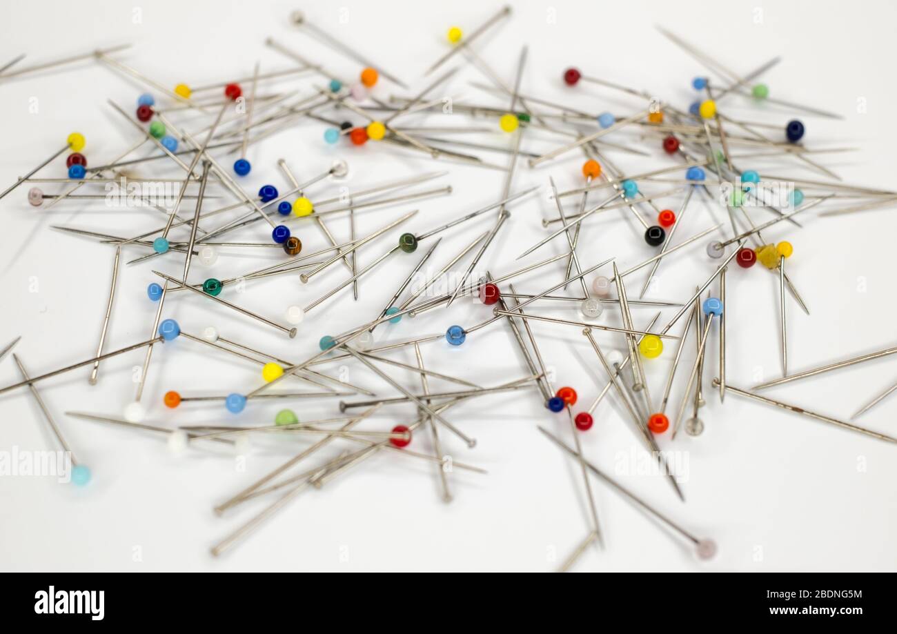 Colorful pins on white background Stock Photo - Alamy