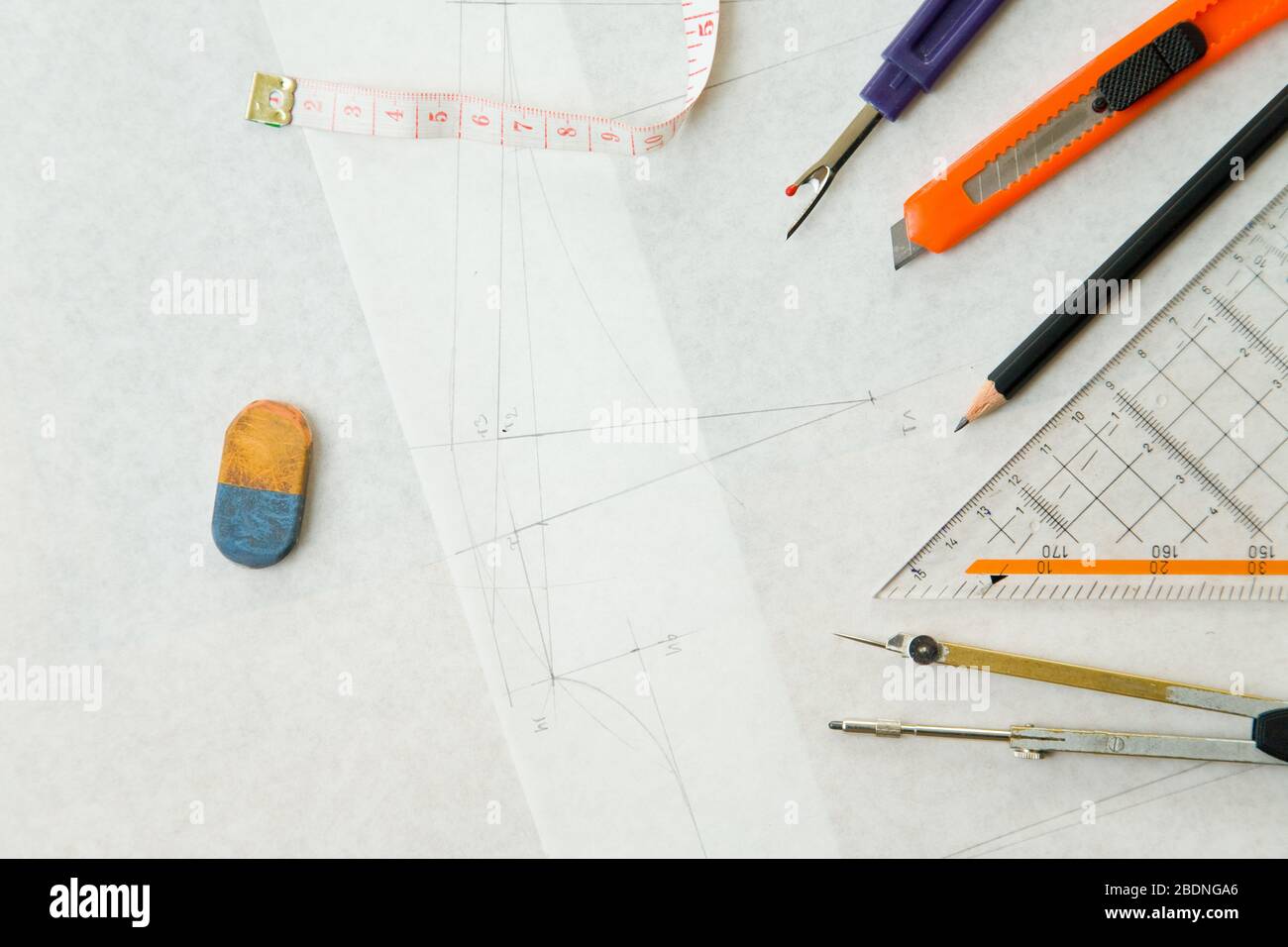 A fashion designer's tools such as pencil and compass on sewing pattern Stock Photo