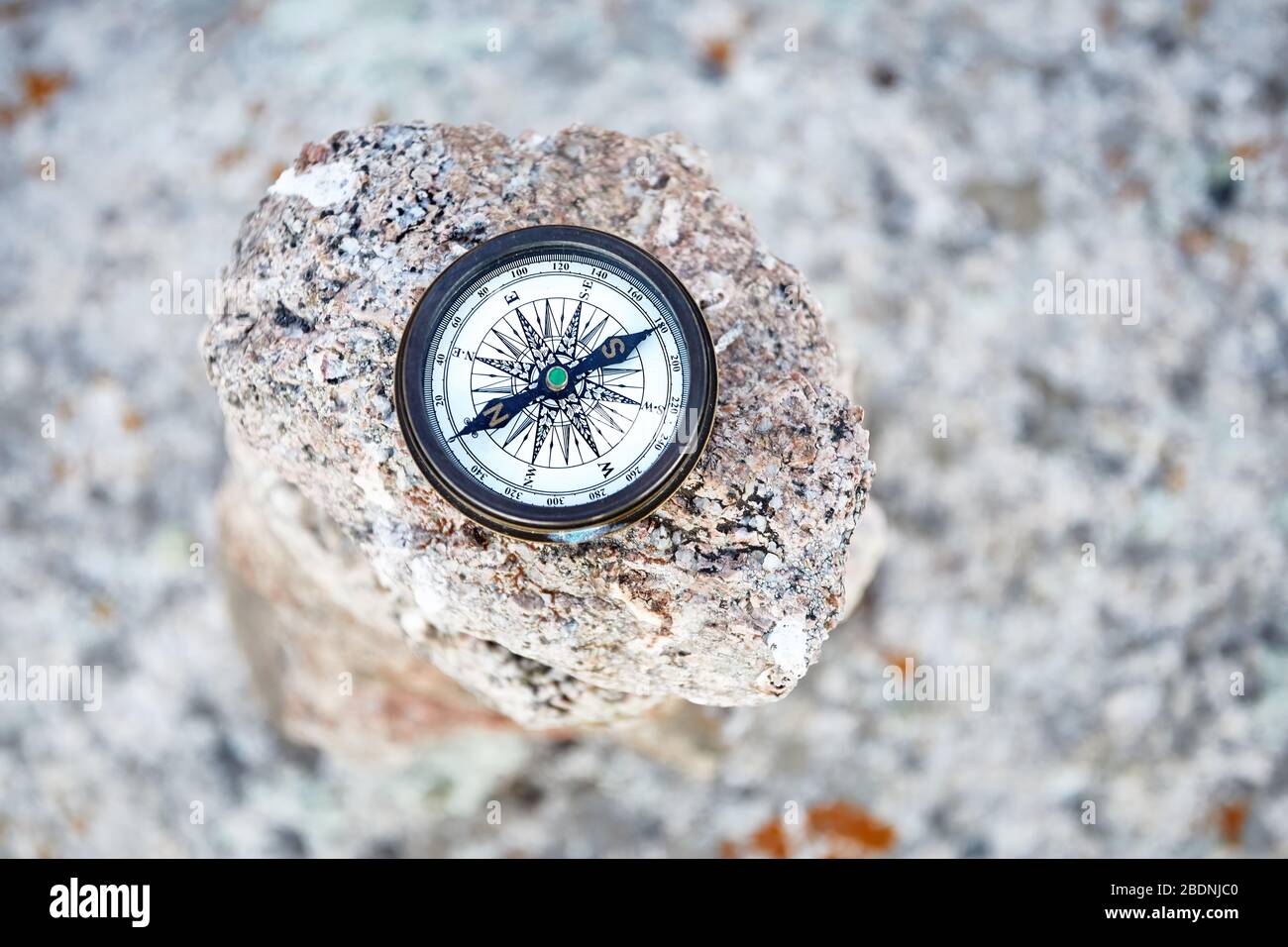 Round Vintage Compass on the stone background. Travel and adventure concept. Stock Photo