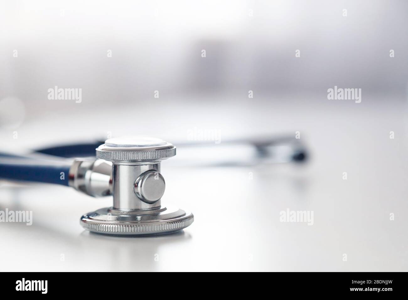 Medical stethoscope or phonendoscope on white table. Acoustic medical device for auscultation Stock Photo