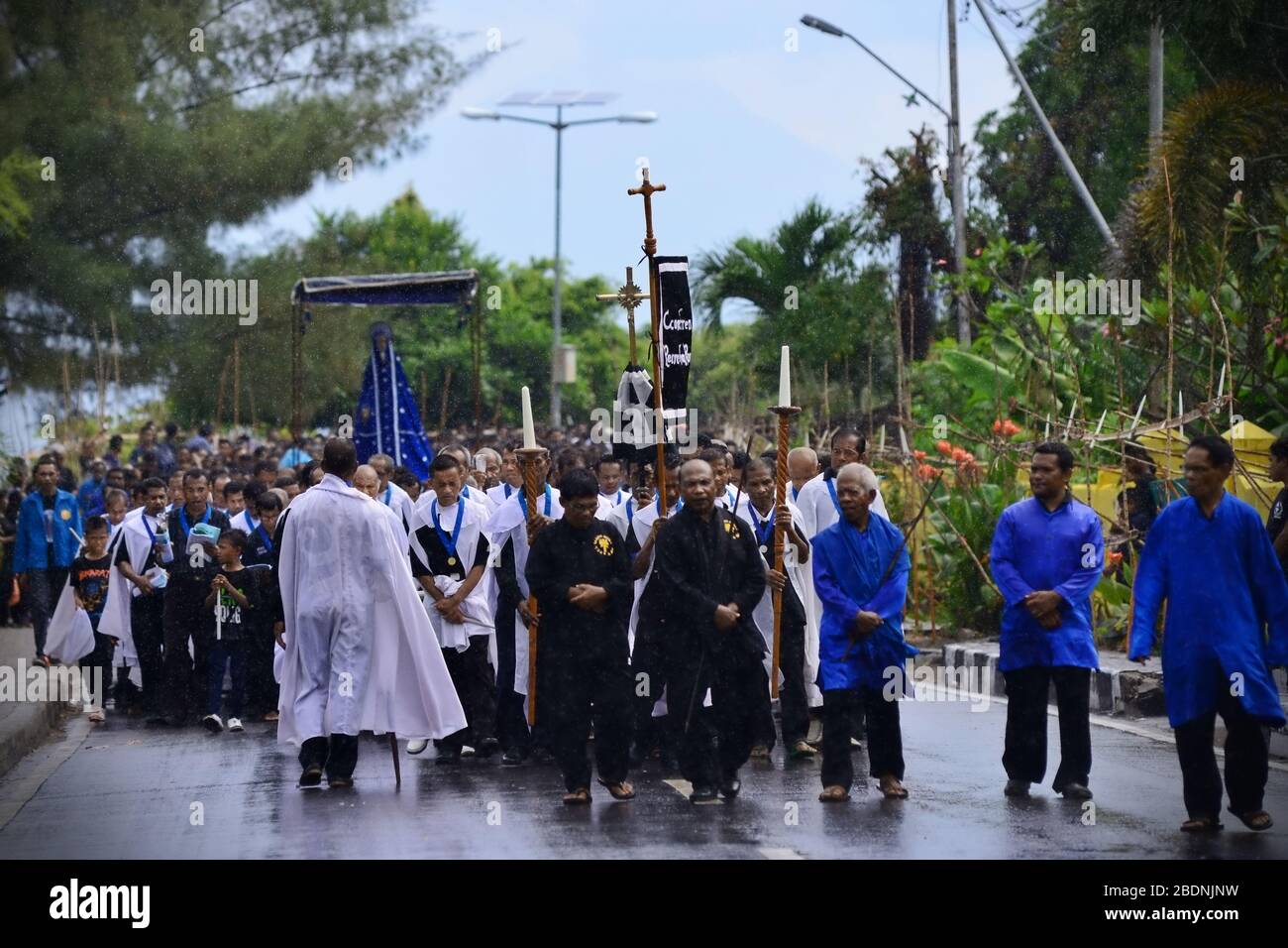 Chapel elders lead congregation to bring Tuan Ma (Mother Mary) statue to Larantuka Cathedral during Holy Week procession on Good Friday in Indonesia. Stock Photo