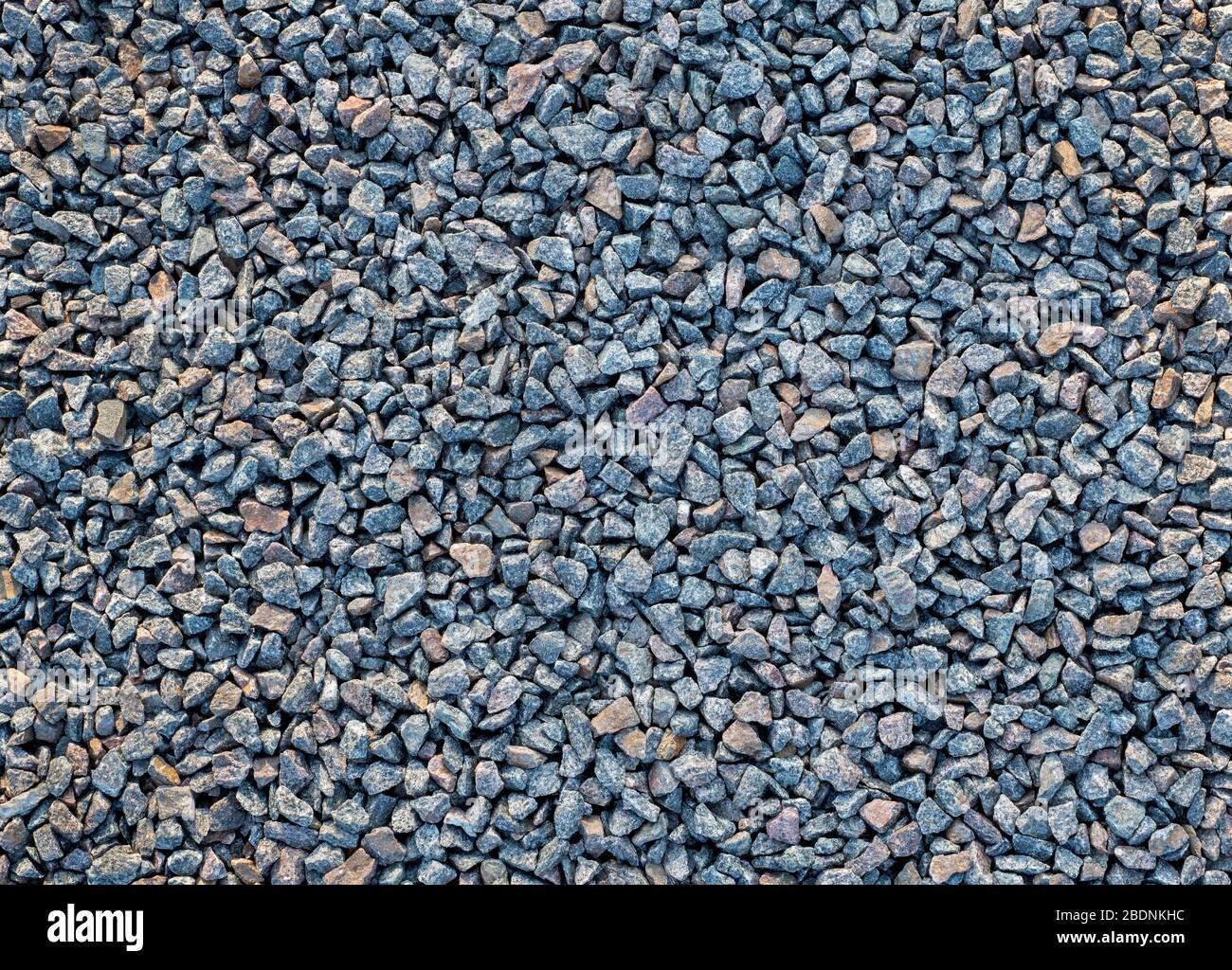 Crushed stone scattered on the ground. Large crushed stone for