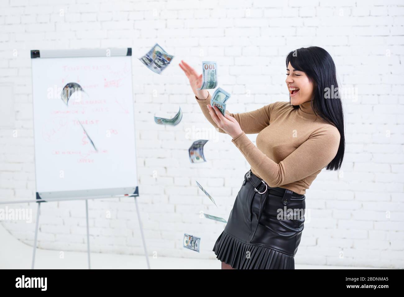 Photo of a charming woman with a smile holding money in her hands and