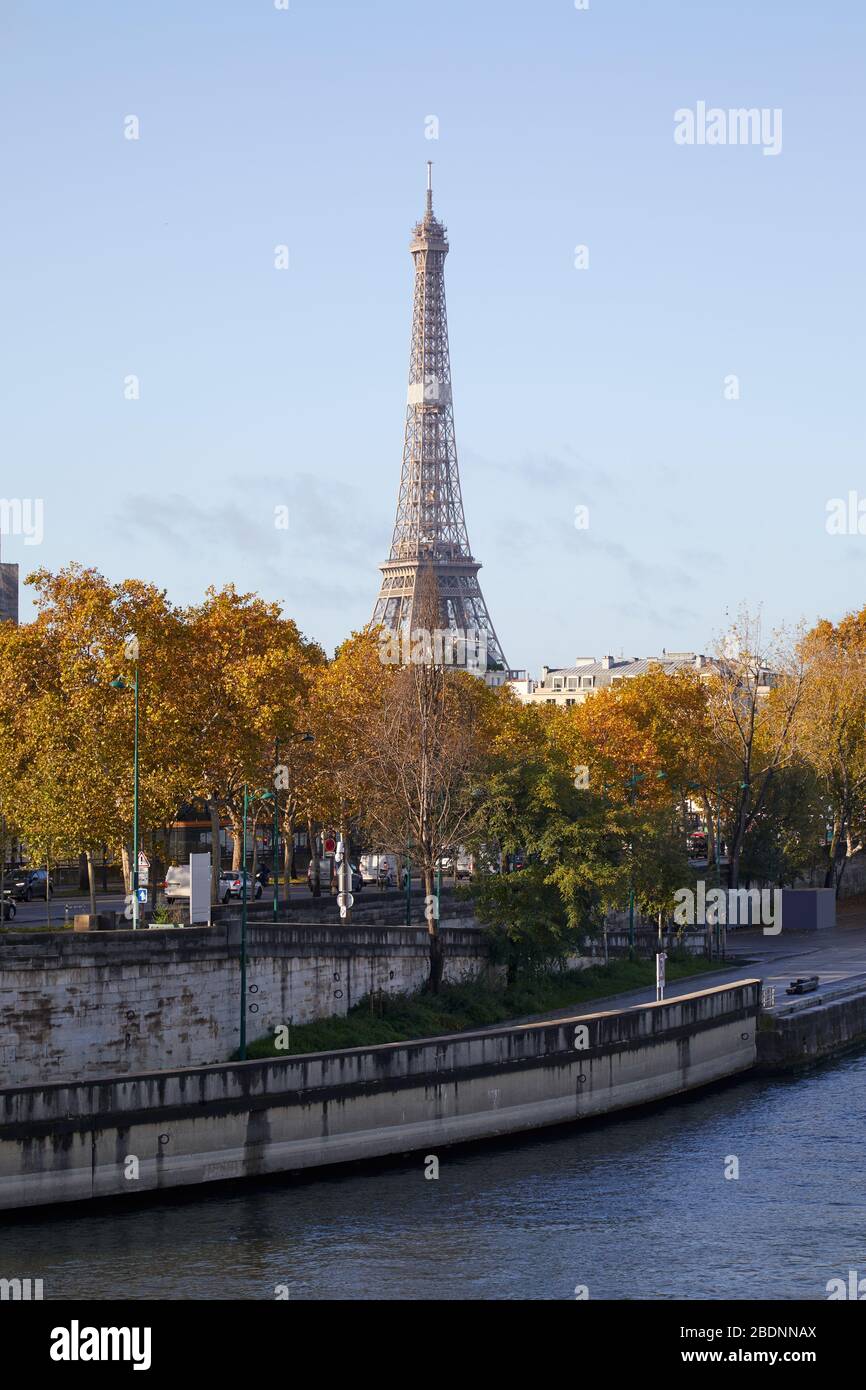 Eiffel tower and Seine river docks with autumn trees in a sunny day in Paris, France Stock Photo