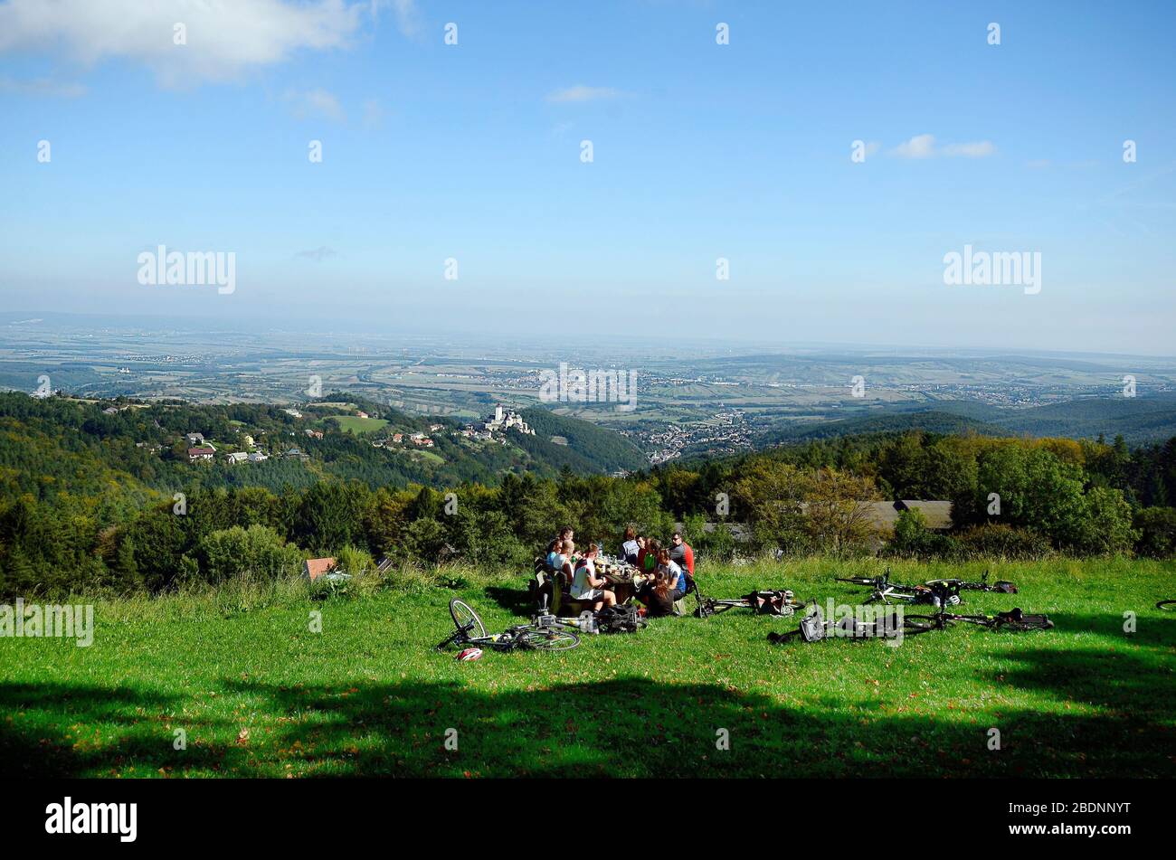 Forchtenstein, Austria - September 28, 2014: Group of unidentified cyclists rest in Rosalia mountains with view to village and castle Forchtenstein in Stock Photo