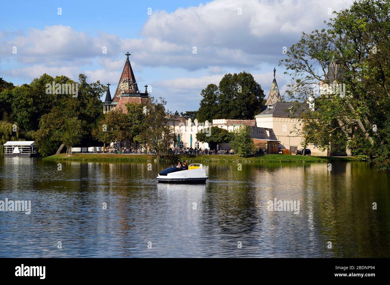 Laxenburg, Austria - October 15, 2011: Unidentified people in kind of boat and castle Franzensburg with cafe-restaurant, the tiny castle is situated o Stock Photo
