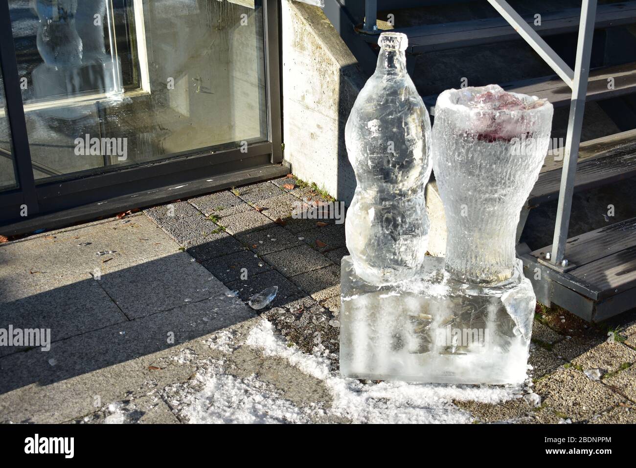 Ice sculpture of a soda bottle and glass in Uetliberg Stock Photo