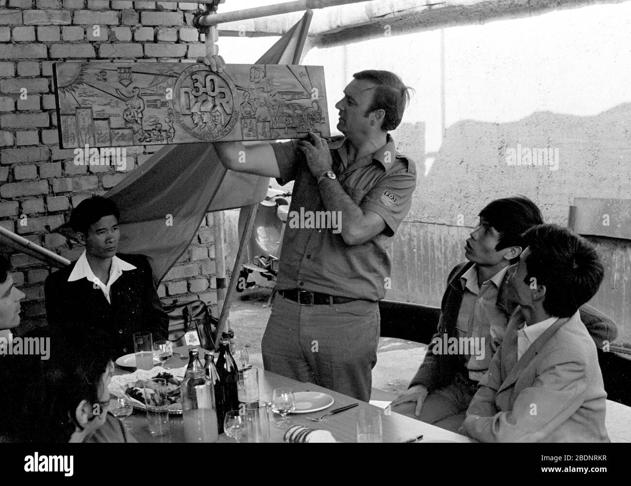 30 November 1979, Saxony, Leipzig: The construction site of the Leipzig Gewandhaus at Karl-Marx-Platz in Leipzig (today Augustusplatz) is visited by a Vietnamese delegation in the early 1980s. Construction site manager Peter Kunze (3rd from right) presents a carved wooden plaque in memory of the 30th anniversary of the GDR. Exact date of recording unknown. Photo: Volkmar Heinz/dpa-Zentralbild/ZB Stock Photo