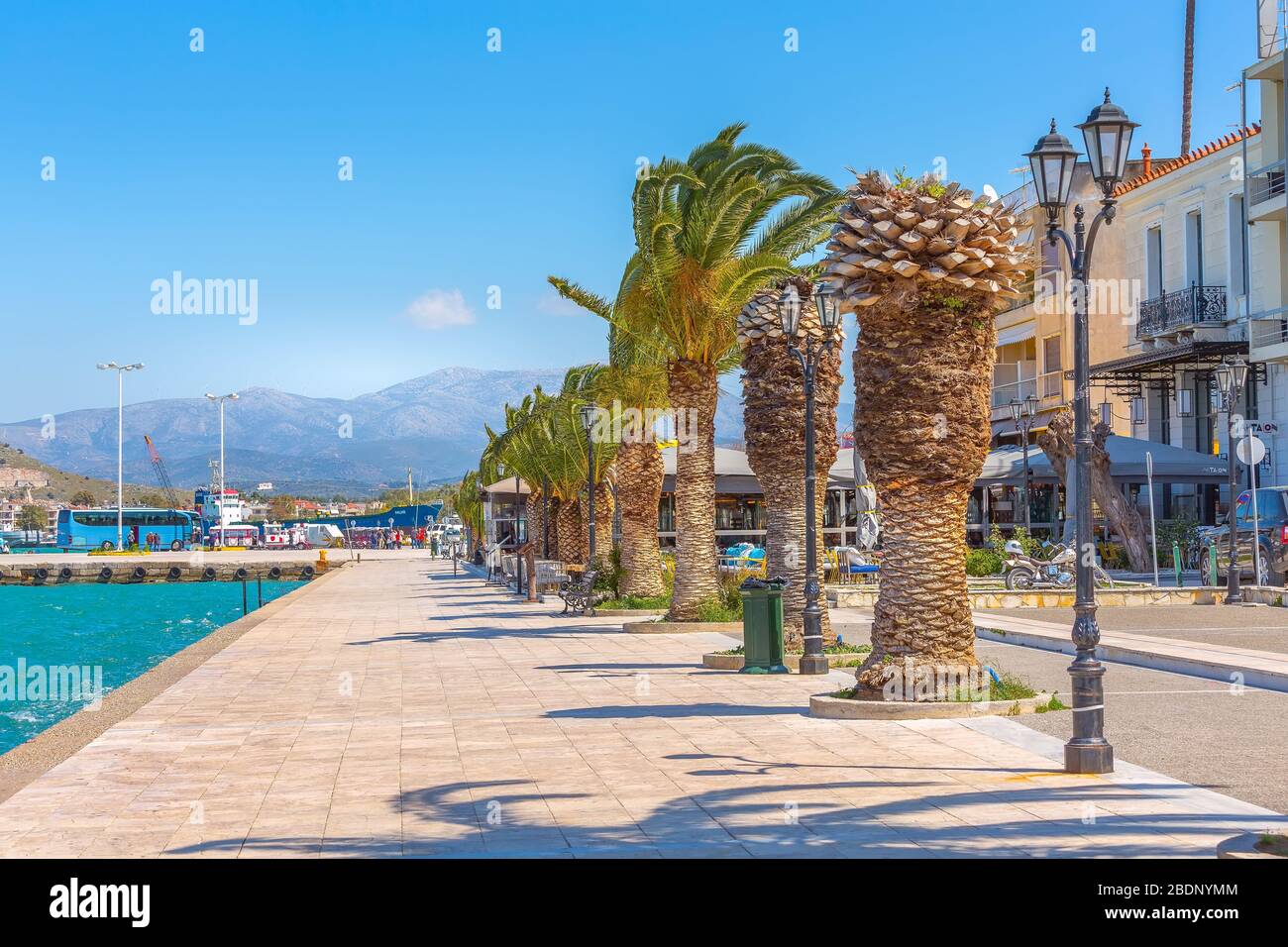 Nafplio, Greece - March 30, 2019: Promenade with palm trees sea in Nafplion, Peloponnese Stock Photo