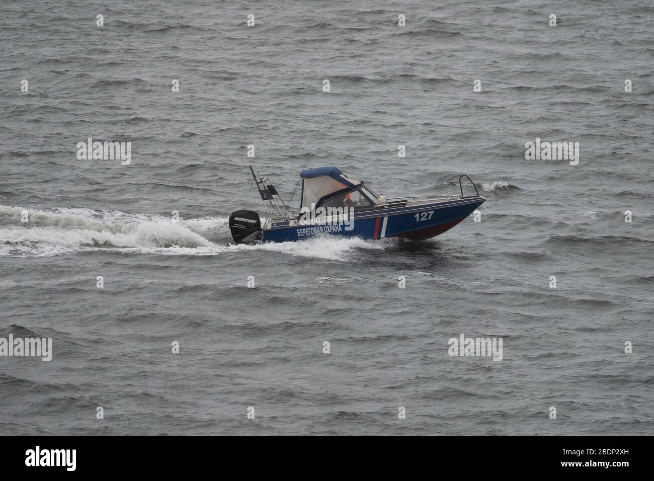 Pevek, Russia - August 1, 2019: The patrol boat of the coast guard of the port of Pevek in patrol. Stock Photo