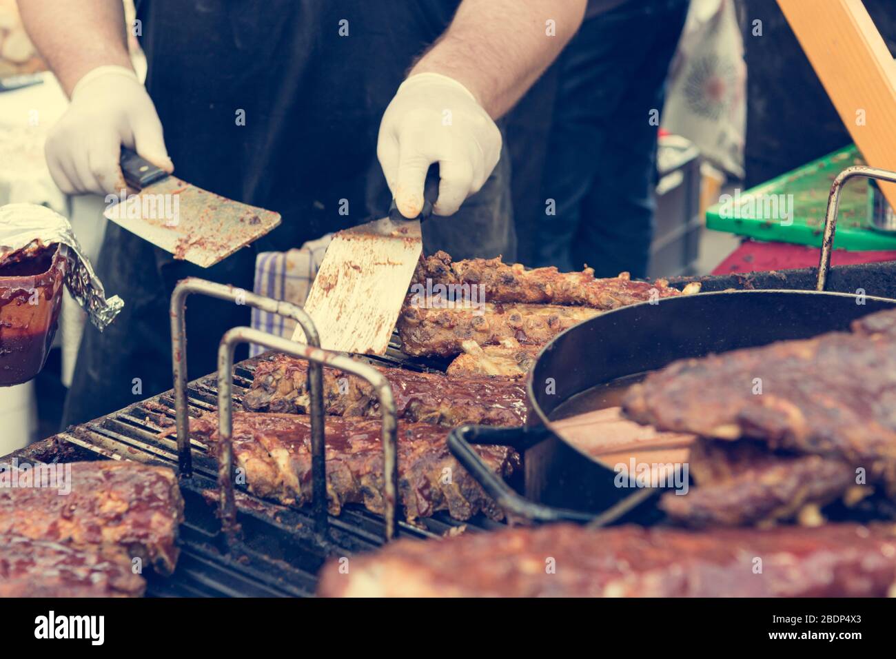 Cheff preparing delicious barbeque spare ribs on a grill Stock Photo ...