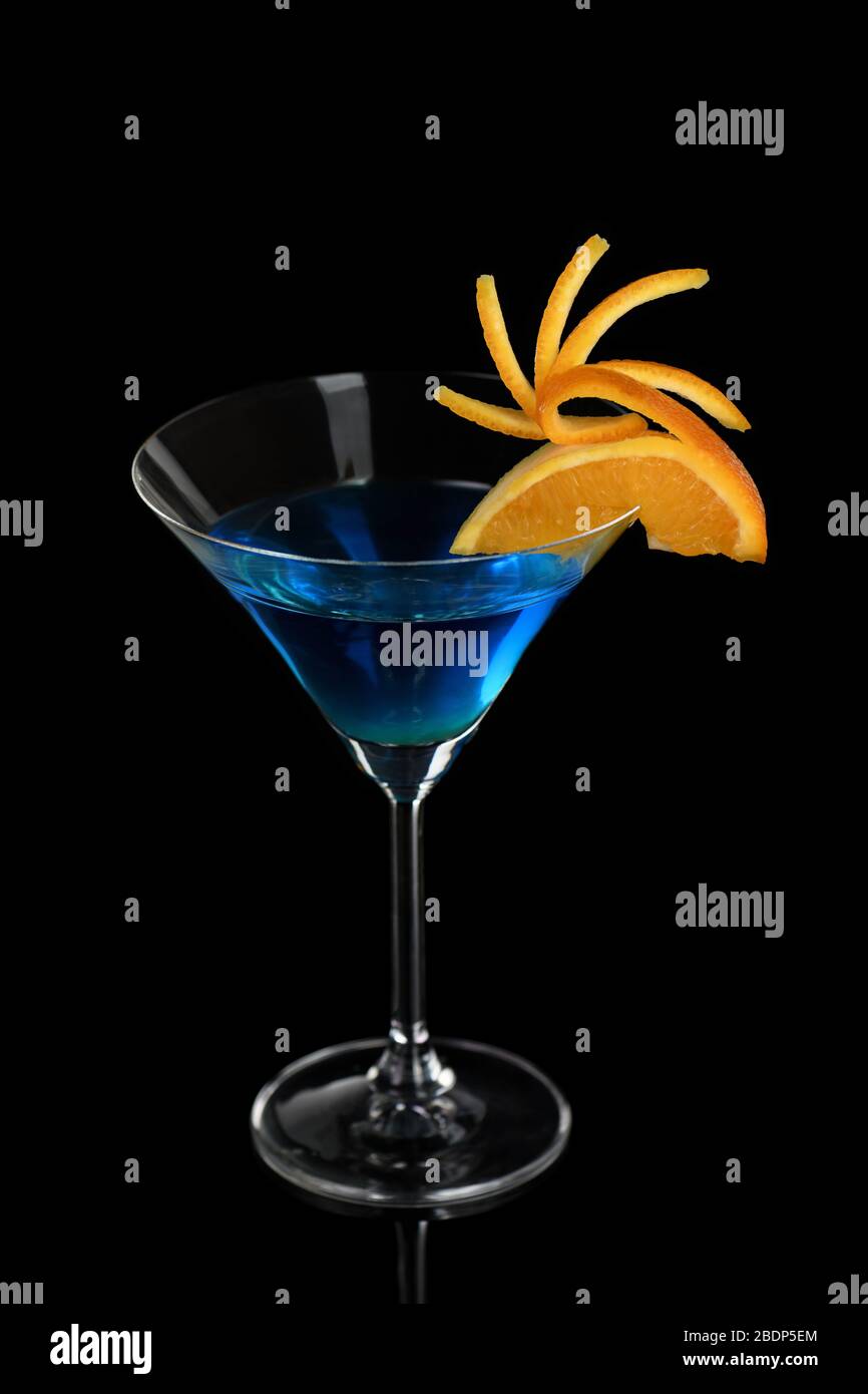 Decoration for a cocktail of orange. Elegant and original presentation. Martini Blue Curacao on a black background Stock Photo