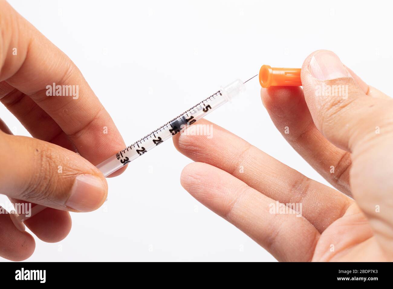 Hand holding an insulin syringe before being used Stock Photo Alamy