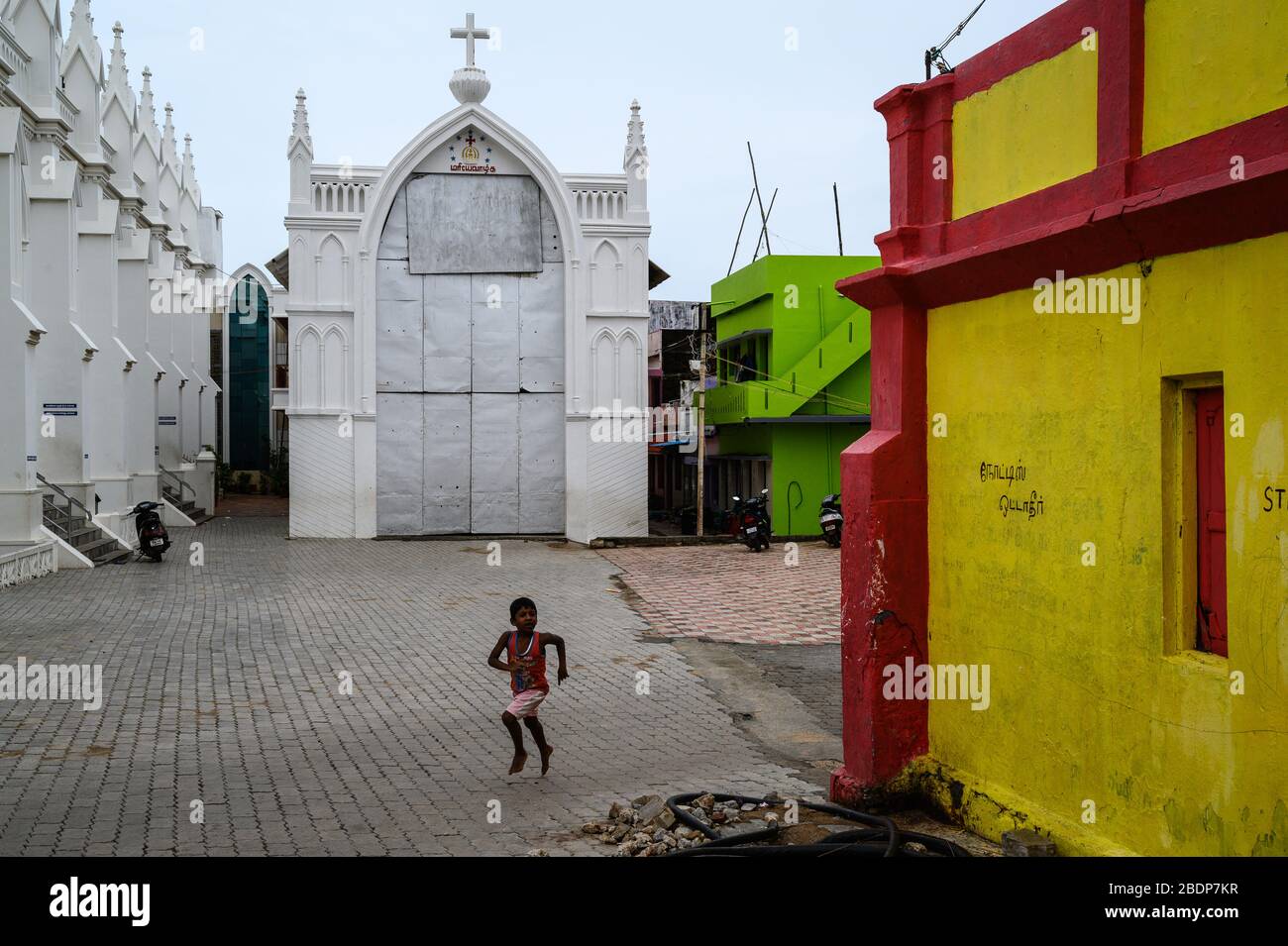 Boy running by Our Lady of Ransom Church, Kanyakumari, India Stock Photo