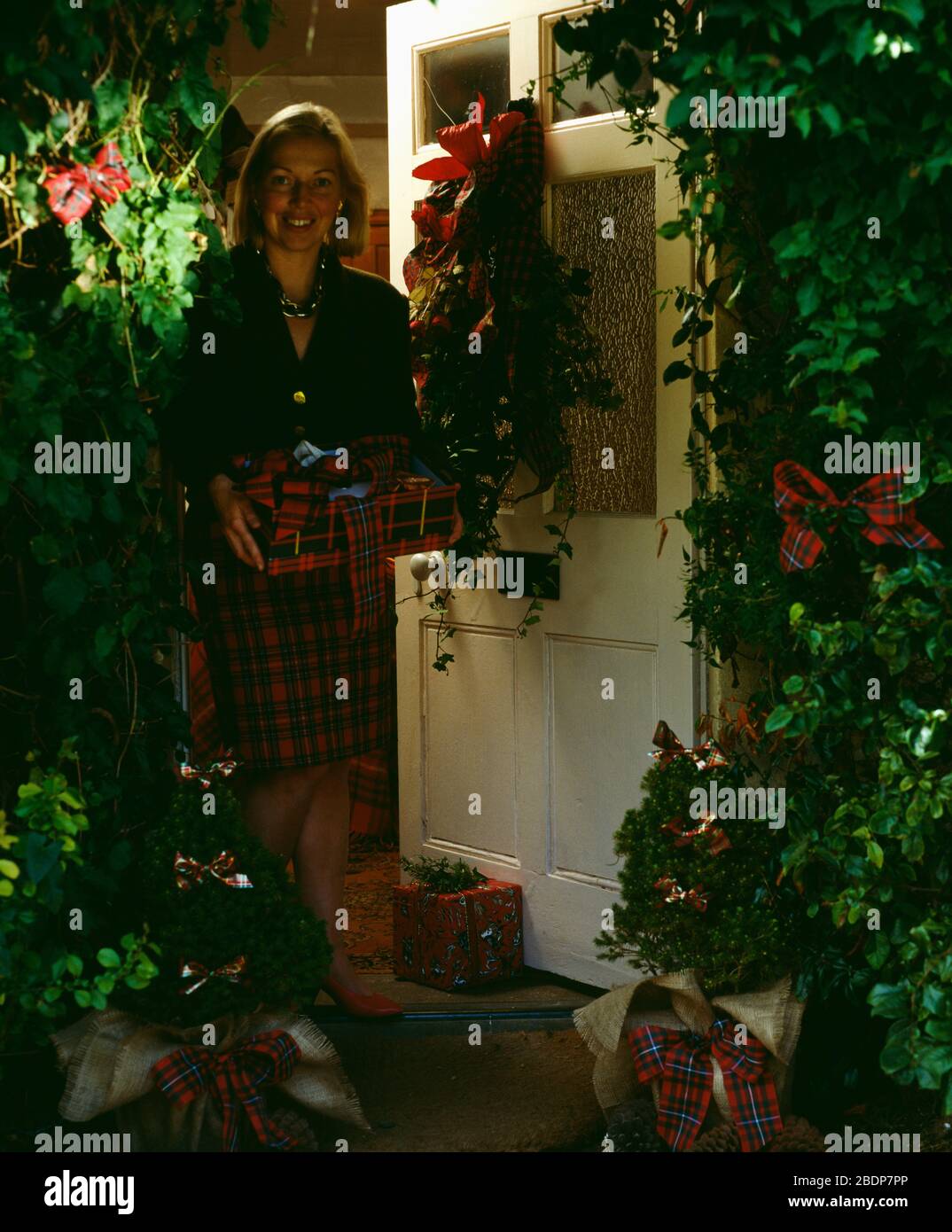 Woman welcoming at door hi-res stock photography and images - Alamy